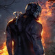 Trapper character in Dead by Daylight standing in a dark forest with the outline of his hunched body outlined by flames in the distance.